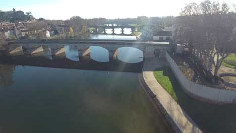 Low-altitude-flight-over-bridges-and-river-Orb-in-Beziers-France-drone